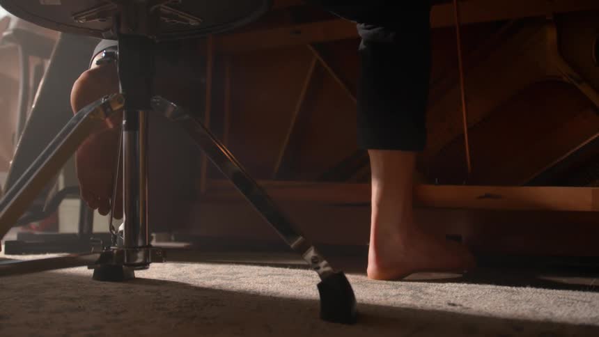 Foot of a person sitting barefoot hitting a rug