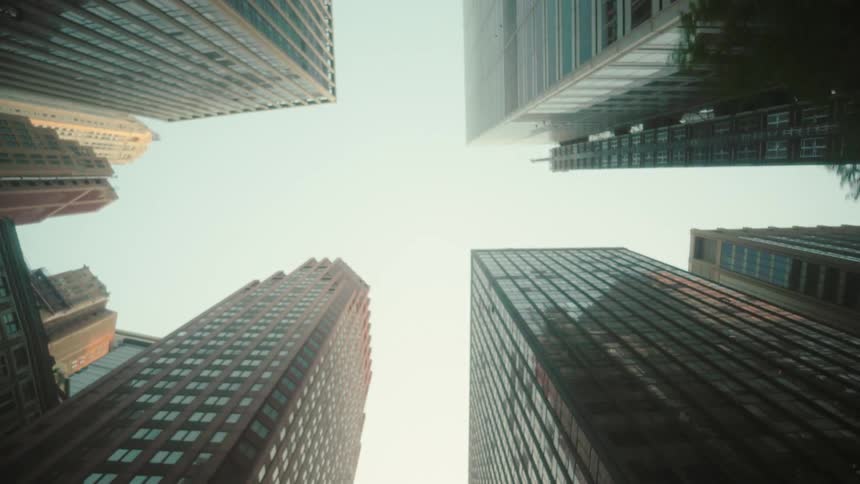 Upward view of modern skyscrapers against the cloudy sky