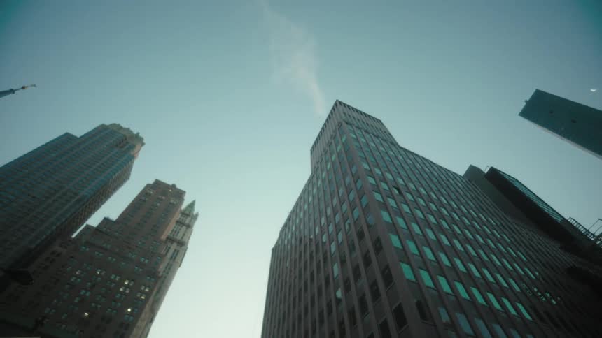 A city skyline at midday with a series of skyscrapers lining the city
