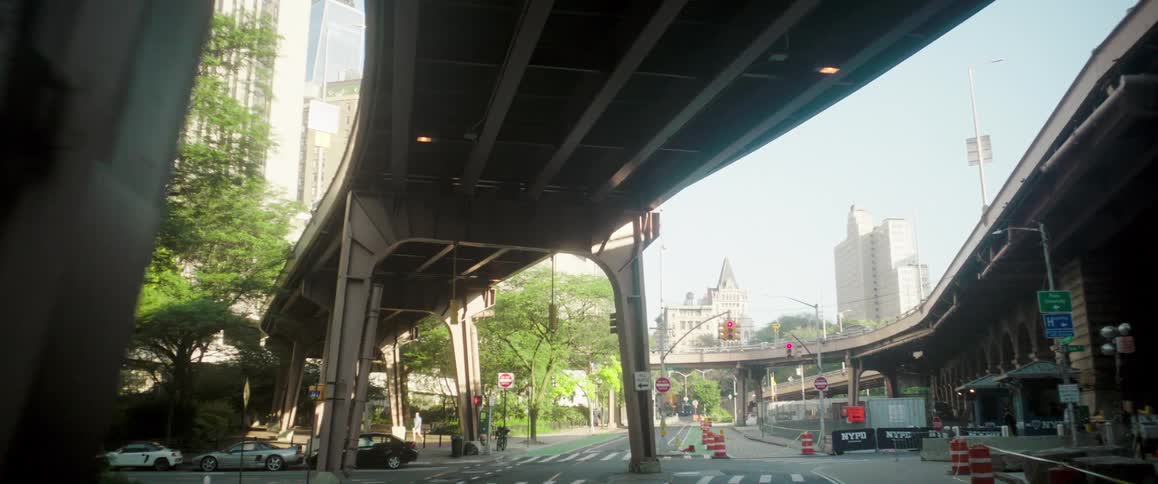 Multiple elevated highways pass over city streets near a road construction zone