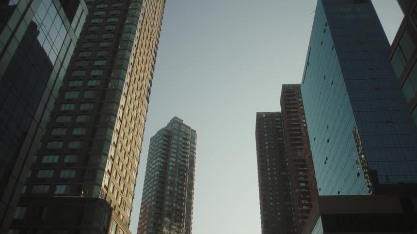 Buildings with reflective facades reflect other nearby downtown skyscrapers