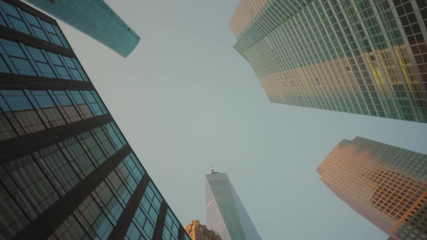 Upward view of skyscrapers against a blue sky