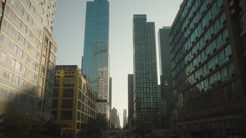 Urban street in a metropolis with skyscrapers and vehicle traffic