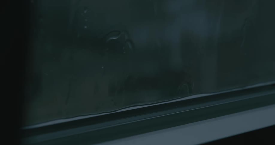 A window with rainwater running down the glass
