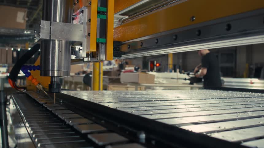 Machines and workers are working in the factory