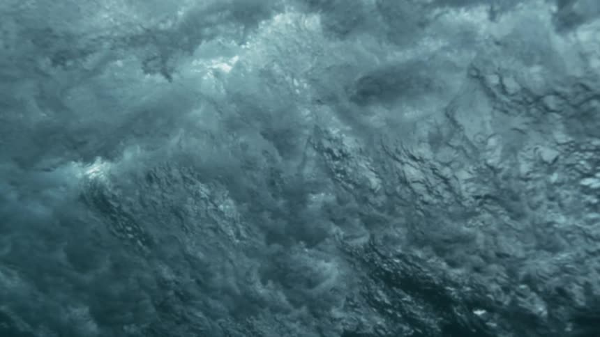 Murky dark water with reflections of light while waves are moving