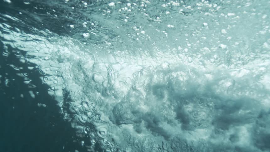 The underside of rippling water creates an abstract wavelike pattern from below the surface
