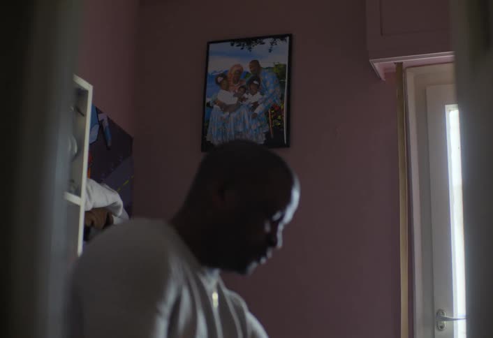 The man is folding clothes at home