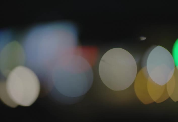 Blurry multicolored lights passing by