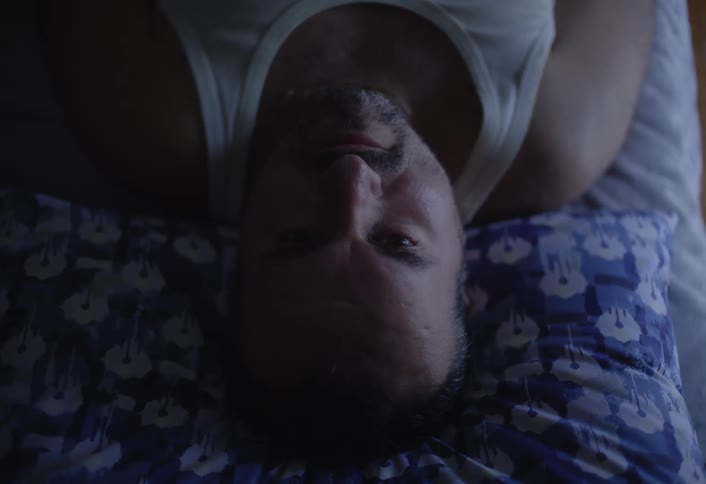 Man lying down sleeping and waking up