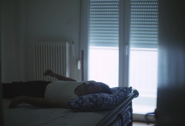 The man is sleeping in bed