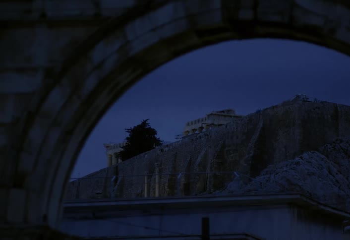 Classical architecture of a temple on a high mountain seen through an arch in the foreground