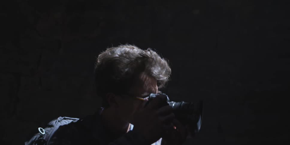 Man taking pictures in a cave