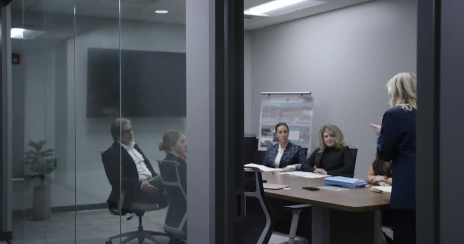 Busy woman gives presentation appearing slightly tense
