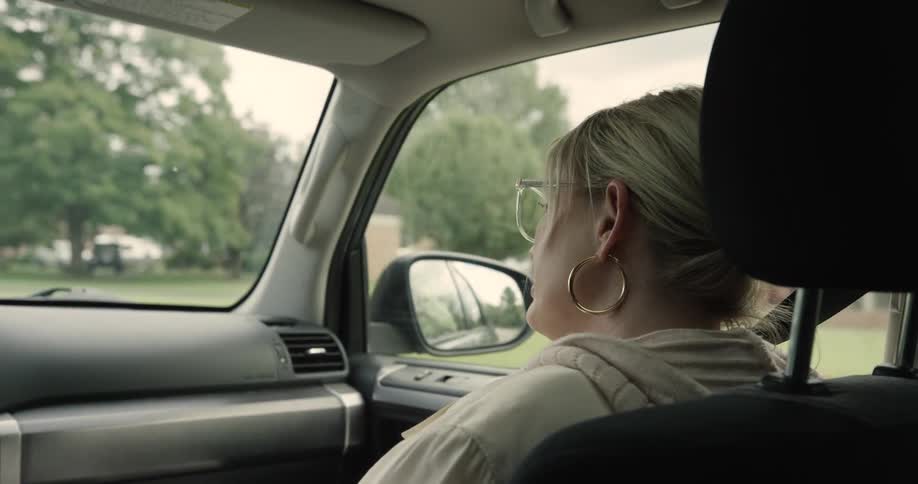 Woman talking inside a moving car