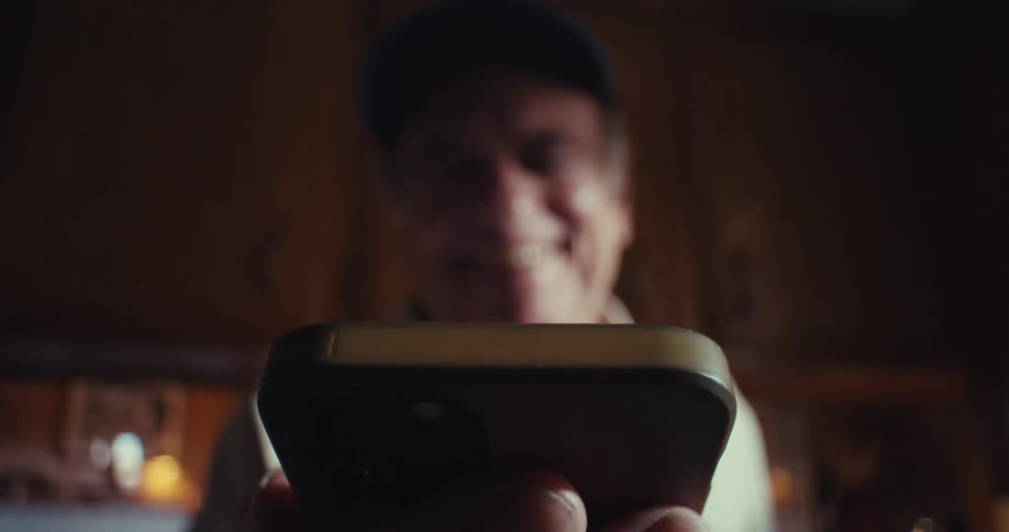 Elderly man interacting with a smartphone