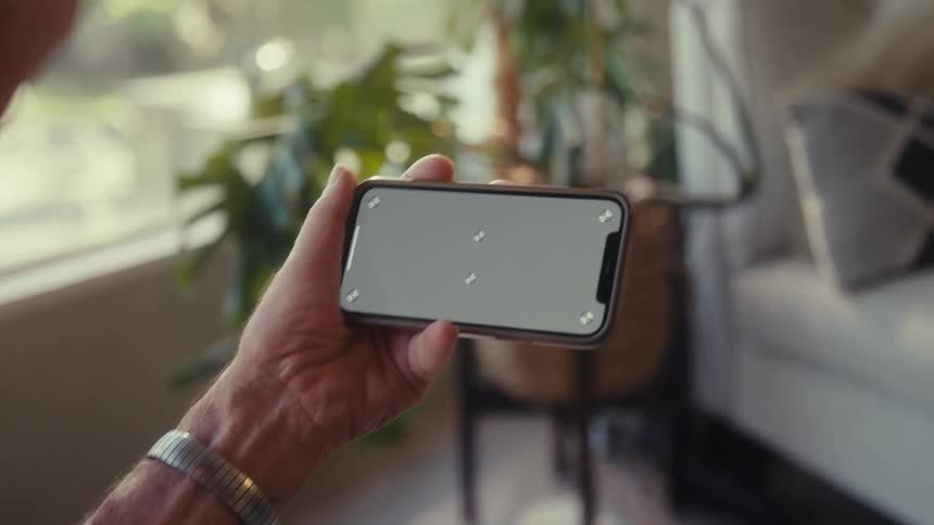 Pair of hands of a person interacting with a smartphone