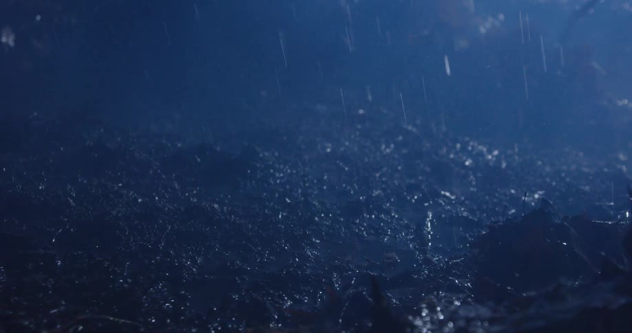 Rain falling on a clay area at night