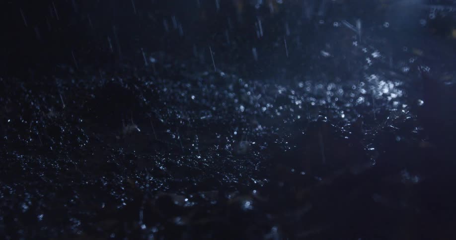 Rain falling on the ground with mud at night