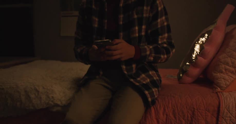 Boy taking a smartphone and typing