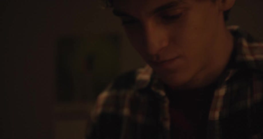 Young man typing on a smartphone
