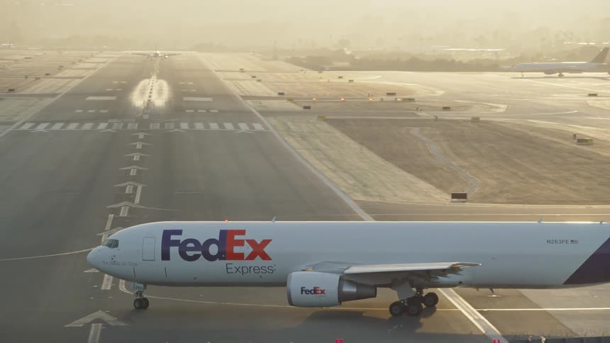 Fedex airplane taxing from gate to the runway at an airport