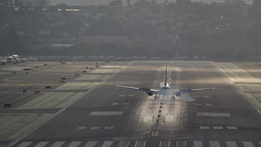Airplane landing on runway at airport