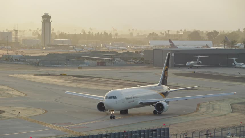 Airplane moving slowly along an airport runway
