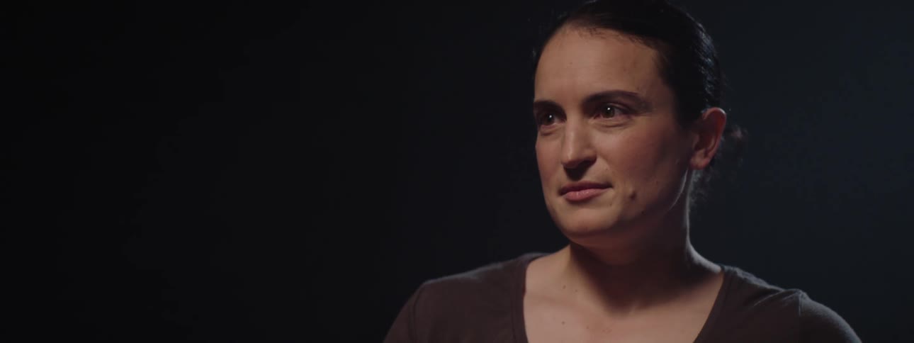 A light shines on a womans face