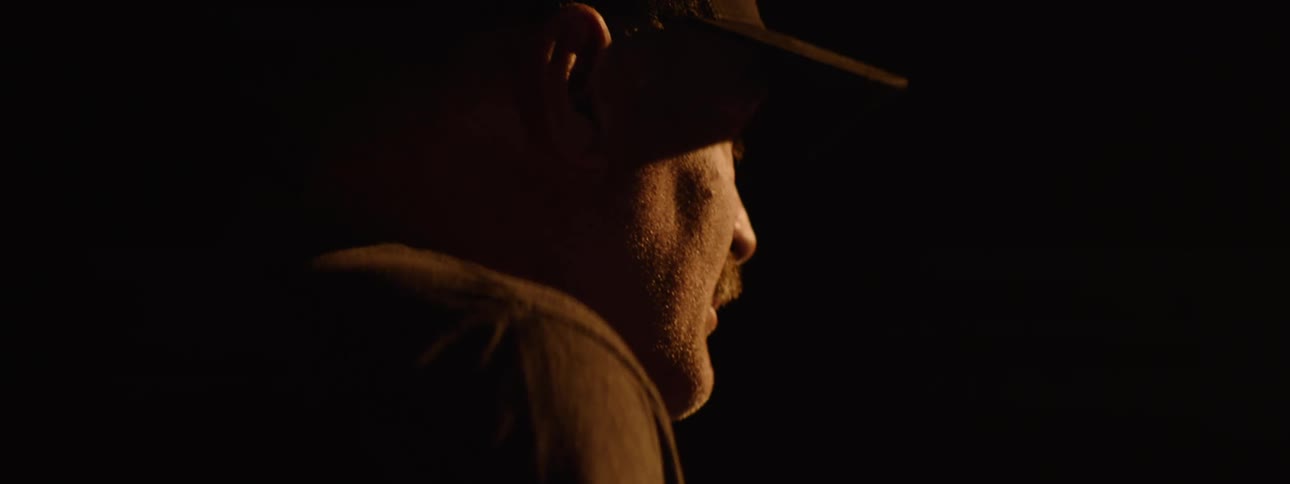 A man is standing in a dark room