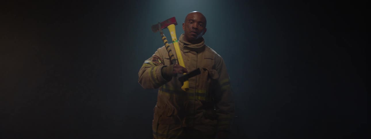 The fireman is holding an ax