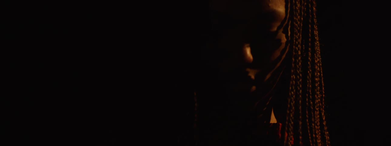 Portrait of a young woman in a lowlight space