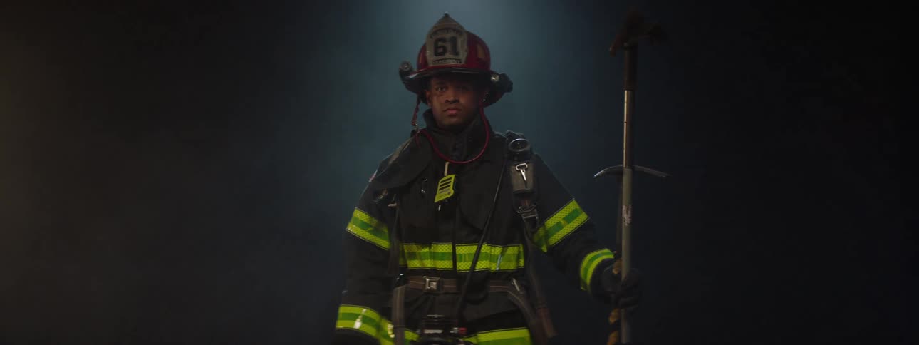 A fully equipped firefighter standing on a stage rotating 360 degrees