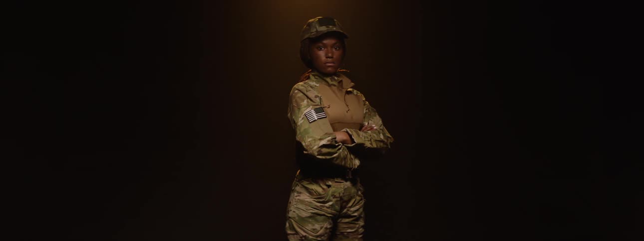 Female military soldier in uniform with arms crossed
