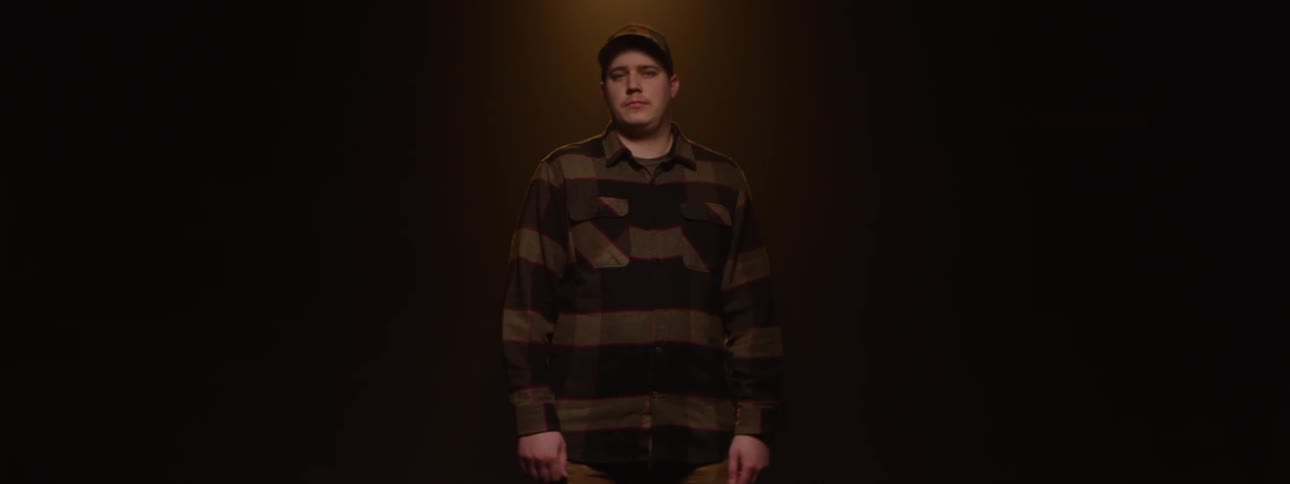 Man wearing a cap in a studiolit environment