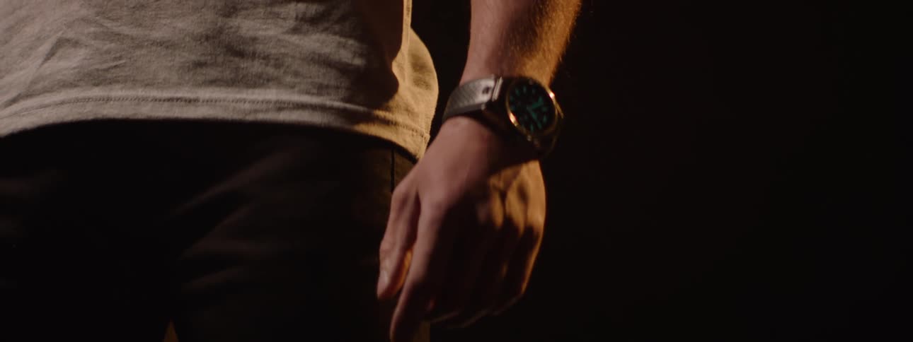 A man is wearing a glow in the dark watch