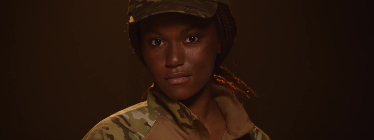 Woman with a cap and wearing a military uniform