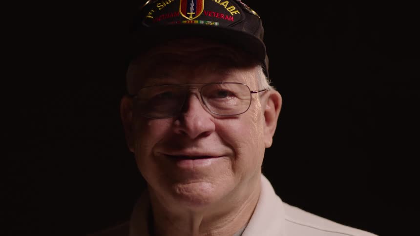 Smiling elderly man in cap and glasses