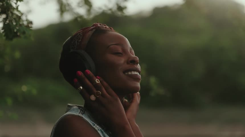 Young woman listens to music on her headphones