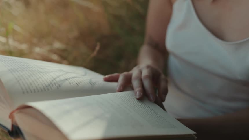 Closeup of a person's hands holding an open book