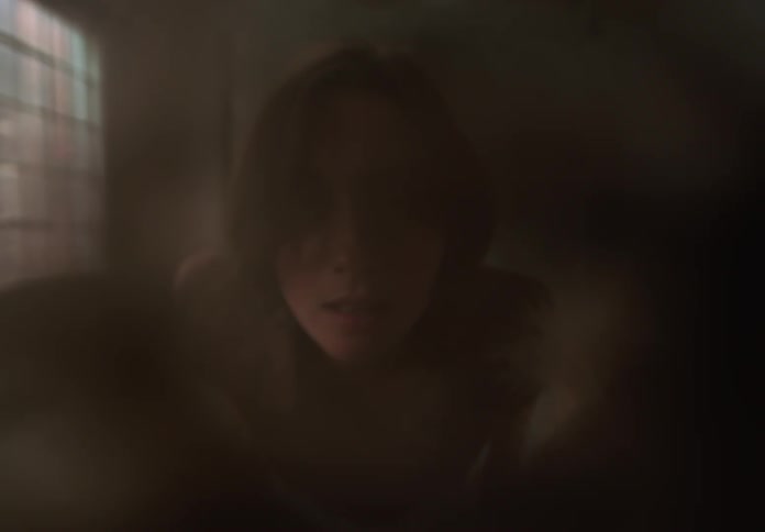 Woman making abstract movements in an indoor environment