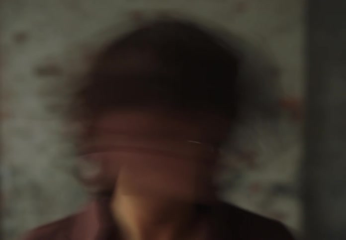 Woman turns head left and right while looking into the camera