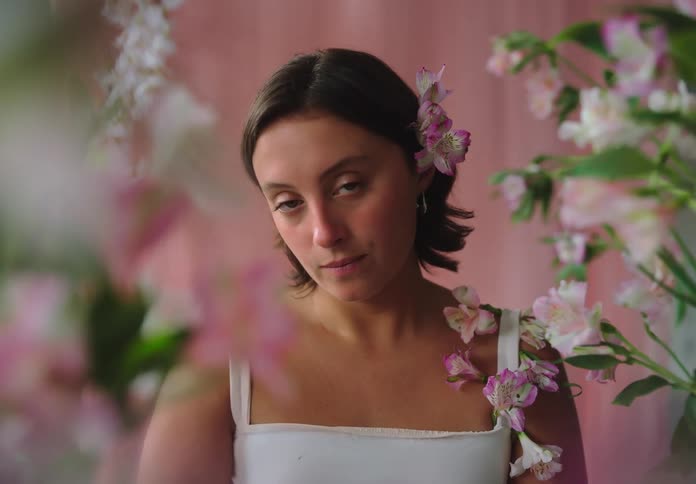 Woman with short hair in a frame with flowers