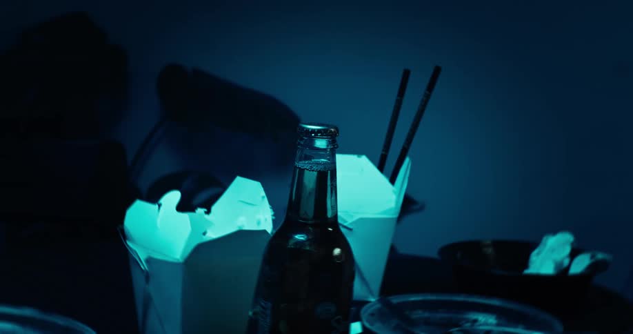 A bottle of drink placed next to two chinese takeout containers