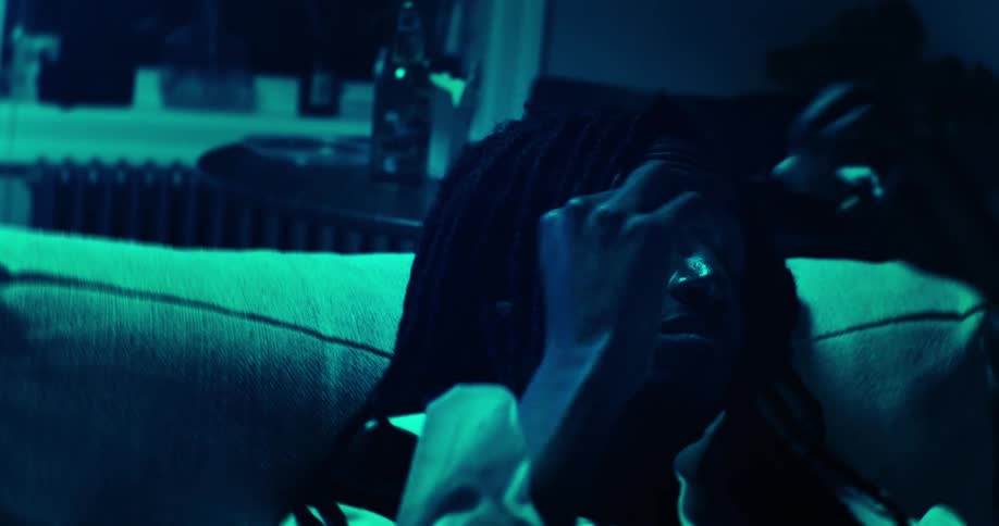 A man is resting on the couch