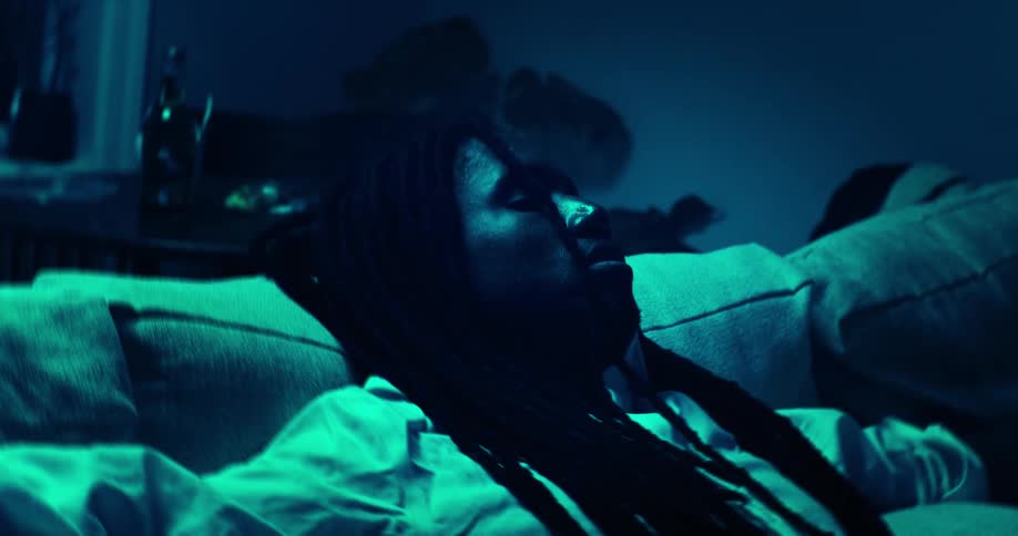 A man relaxes on a sofa