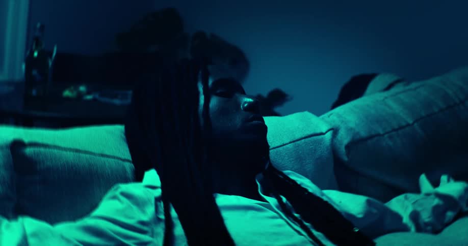 Dreadlocked man lying down sleeping