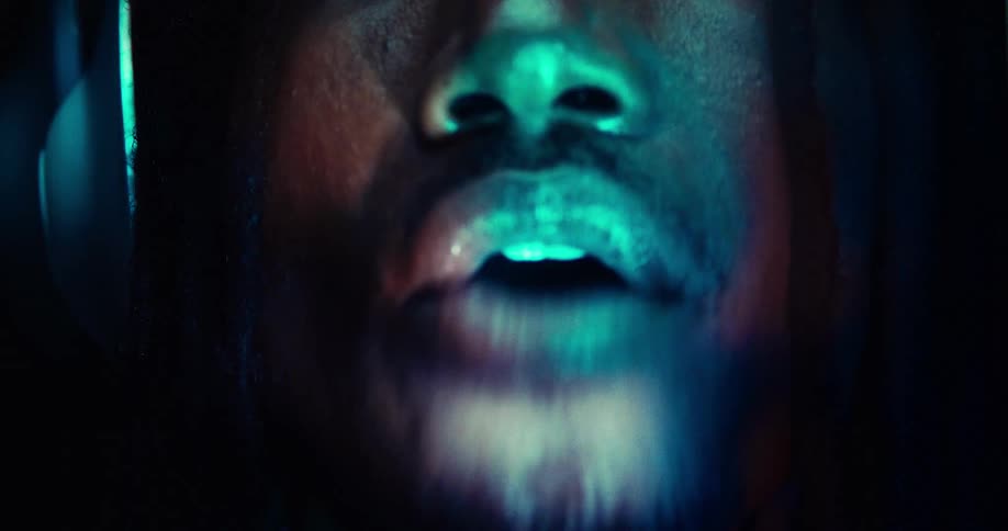 Closeup of a mans mouth with light reflection talking