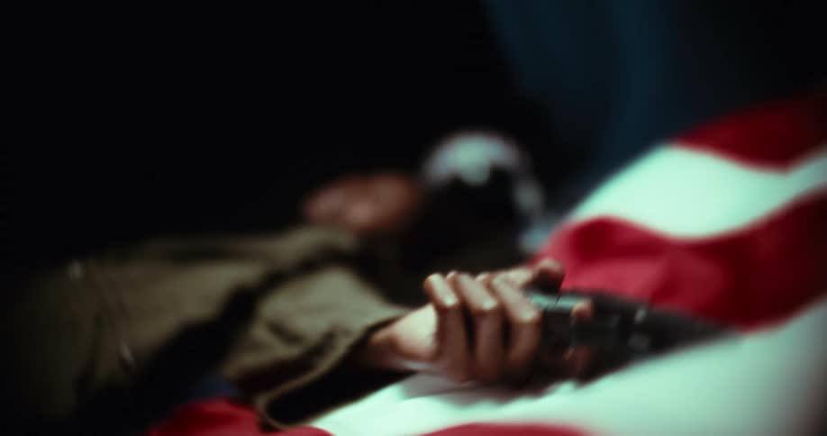 Man lying down holding a pistol
