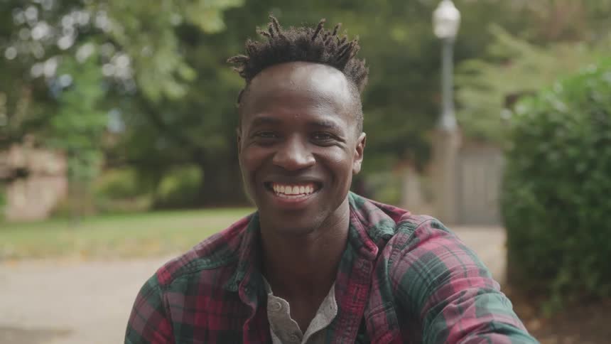 Smiling man in profile outdoors